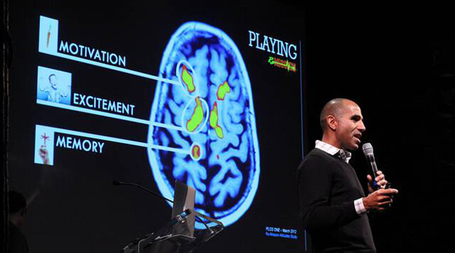 A photograph of a man presenting a study of the brain.  - Chaos Theory | Serious Games Developer, Australia